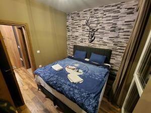 a bedroom with a bed with a plate of food on it at Mavrovo ski apartment in Mavrovo