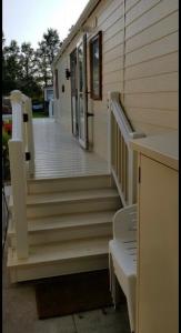 a wooden porch with stairs leading to a house at 53 The Duckpond, St Minver in Saint Minver