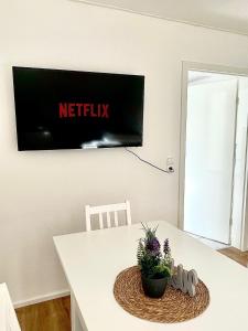 a white table with a television on a wall at Eindrucksvolles Gruppen– und Monteursloft in Edingen-Neckarhausen
