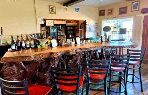 a bar with a large wooden counter with chairs at Panamint Springs Motel & Tents in Panamint Springs