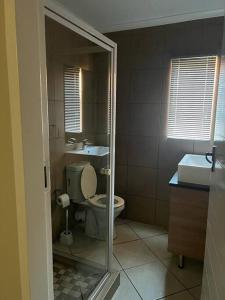 a bathroom with a toilet and a sink at Centurion: Chilled Townhouse in Centurion