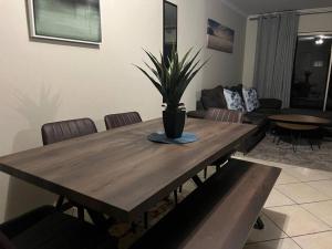 a wooden table with a potted plant on top of it at Centurion: Chilled Townhouse in Centurion