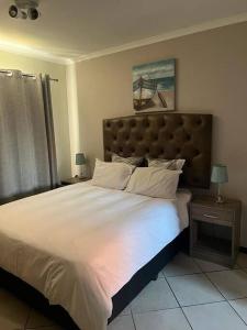 a bedroom with a large bed with a large white comforter at Centurion: Chilled Townhouse in Centurion