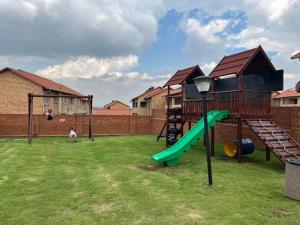 a playground with a slide and a slideintend at Centurion: Chilled Townhouse in Centurion