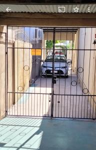 a gate with a car parked in a garage at Departamento Centeno. Centrico. in Santa Rosa