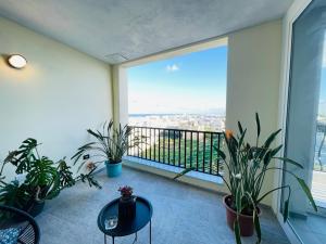 a room with plants and a balcony with a view at 190 Sqm Apartment in Swieqi with Views and free high speed Wifi in Is-Swieqi