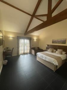 a large bedroom with a large bed and a window at Kings Croft Hotel in Pontefract