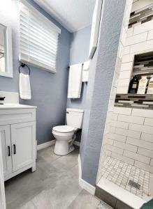 a bathroom with a white toilet and a shower at Private Getaway Studio ! in Lakeland