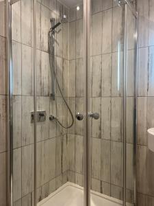 a shower with a glass door in a bathroom at The Aberlour Hotel in Aberlour