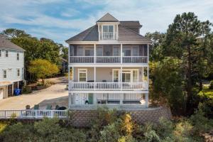 an aerial view of a large house with a balcony at 616 E Erie Driftwood Marsh and River Views Private Pool in Folly Beach