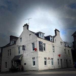 a large white building with two chimneys on top of it at The Aberlour Hotel in Aberlour
