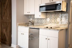 a kitchen with a sink and a microwave at Inn on Main Annapolis in Annapolis