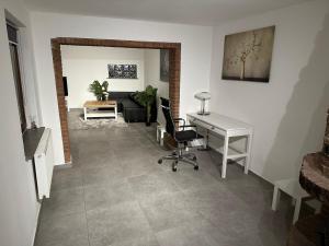 a living room with a desk and a chair at Apartment for rent 2 in Celle