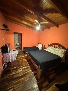 a bedroom with two beds and a ceiling at HOSPEDAJE TAFI in Tafí del Valle