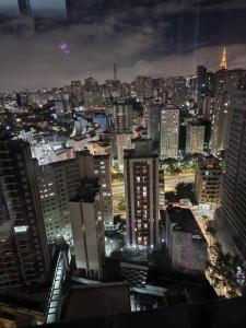 a view of a city at night at Studio SP ao lado Shopping Frei Caneca in São Paulo