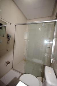 a bathroom with a shower and a toilet at La Bella Hotel in Imperatriz