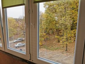 a window with a view of a parking lot at Apartman - Hani in Rakovica
