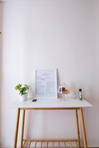 a white table with a certificate and a glass of wine at Venus in Thessaloniki