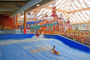 two people on surfboards in a water park at Massanutten Resort by TripForth in McGaheysville