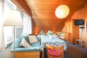 a living room with a blue couch and a table at Haus Wagenknecht in Borkum