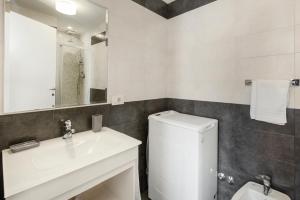 a bathroom with a sink and a toilet and a mirror at White Flat Termini in Rome