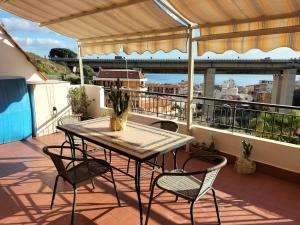 a table and chairs on a balcony with a view at Casa Vacanza Da Rosa in Letojanni
