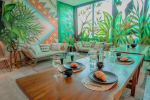 a dining room with a table and a mural at PH-4-Groups 3BR Priv-RoofTop 18Pax @Aldea Zama in Tulum