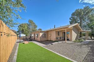 a house with a fence and a yard at Trendy Digs with Yard Games, Fire Pit and Grill! in Cottonwood