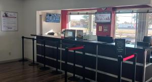 a cashier counter in a store with red arrows at Red Roof Inn Fort Worth West in Fort Worth
