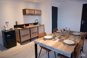 comedor con mesa y cocina en Suite Le Loft & Garden et Spa BY NANCYINTIMELOUNGE en Nancy