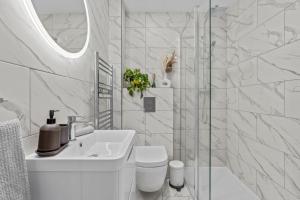 a white bathroom with a toilet and a sink at Cosy Apartment in the heart of Southampton in Southampton