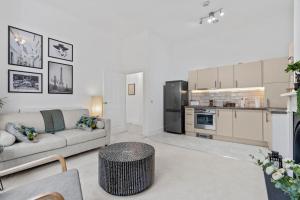 a living room with a couch and a kitchen at Cosy Apartment in the heart of Southampton in Southampton