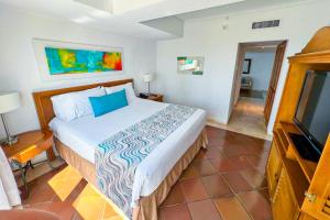 a bedroom with a bed and a flat screen tv at Hotel Almirante Cartagena Colombia in Cartagena de Indias