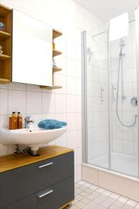 a bathroom with a sink and a shower at HAMA Design Homes in Lippstadt