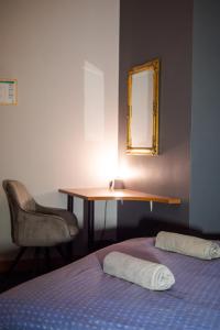 a bedroom with a bed and a desk and a mirror at Cinnamon Sally Backpackers Hostel in Rīga