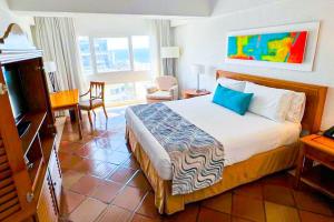 a hotel room with a bed and a living room at Hotel Almirante Cartagena Colombia in Cartagena de Indias