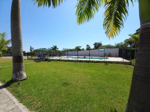a park with a playground and a swimming pool at Kitnet Apartamento Praia Matinhos in Matinhos
