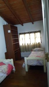 a bedroom with two beds and a window at Tym in Salta