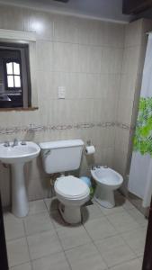 a bathroom with a toilet and a sink at Tym in Salta