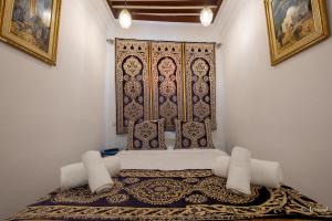a room with a bed with a large window at Riad Bin Souaki in Chefchaouene