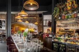 a bar with a long table in a restaurant at Waterfront Luxury in Dublin +28 photos