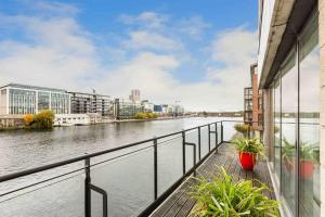 a view of a river from the balcony of a building at Waterfront Luxury in Dublin