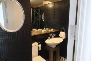 a bathroom with a sink and a toilet and a mirror at Waterfront Luxury in Dublin