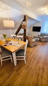 a dining room with a table and a living room at WaldApart Willingen in Willingen