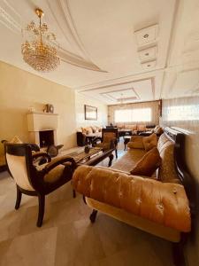 - un grand salon avec un canapé et des chaises dans l'établissement Appart " Haut Standing Marοcain " 120m2 city center, à Tanger