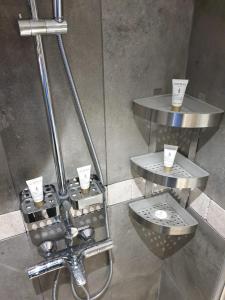 a shower with two tables with cups on them at 5 star Smart studio 30m2 in Flic-en-Flac