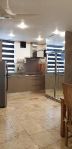 a large kitchen with stainless steel appliances in a room at 5 star Smart studio 30m2 in Flic-en-Flac