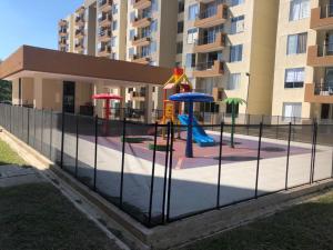 a playground in front of a apartment building at Descanso Total in Ricaurte