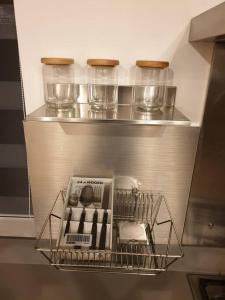 a metal shelf in a refrigerator with bowls and plates at 5 star Smart studio 30m2 in Flic-en-Flac