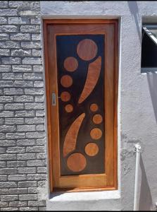a wooden door with a painting on the side of a building at Tia Maria cottage in Cape Town